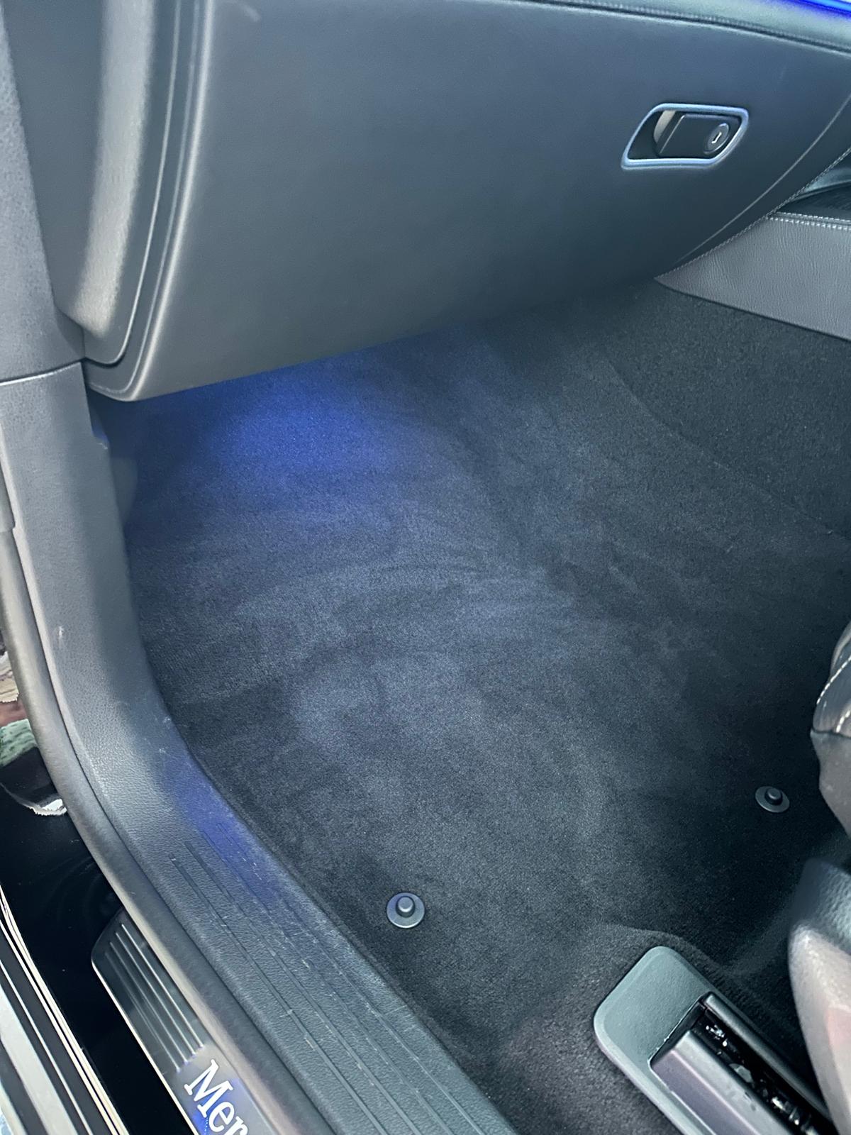 Freshly vacuumed and groomed front footwell carpet of an SUV