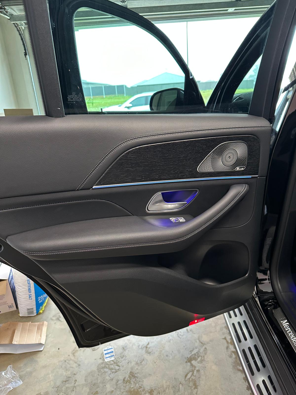Clean door card, speaker grille and stainless sill of an SUV after detailing